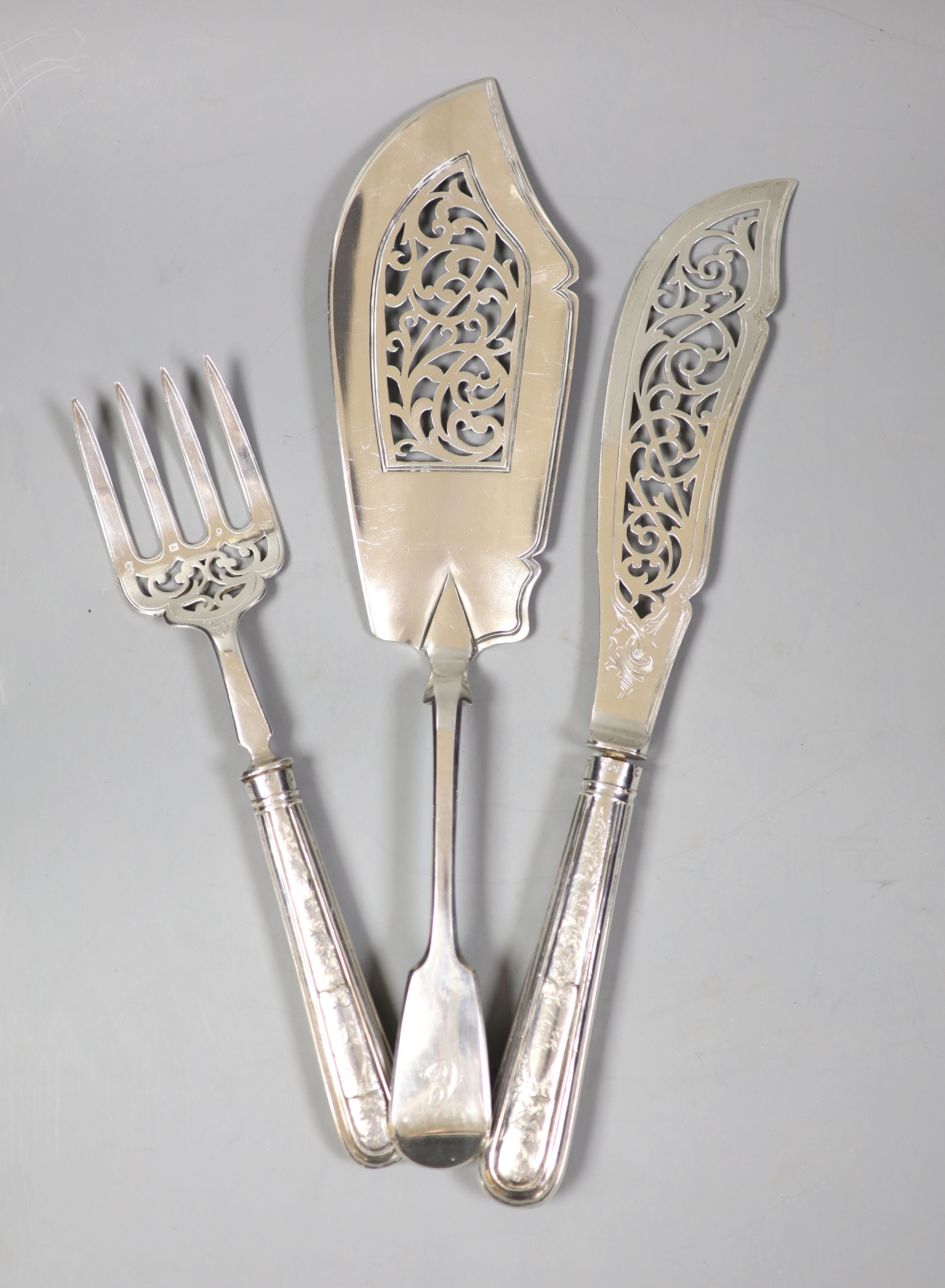 A pair of Victorian silver fish servers with loaded handles, Sheffield, 1853 and a Victorian silver fiddle pattern fish slice.